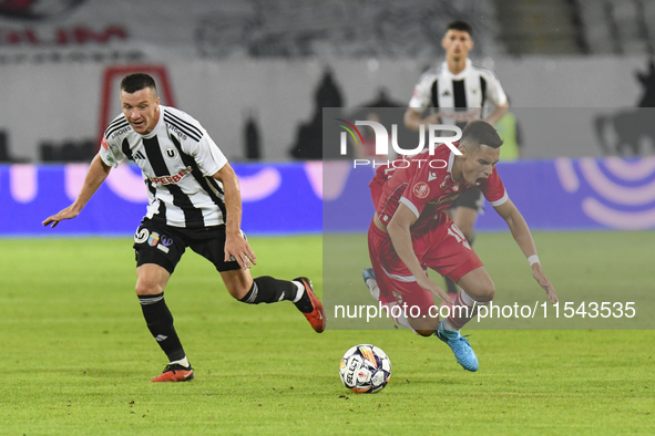 Catalin Cirjan and Vadim Rata are in action during Universitatea Cluj vs. Dinamo Bucuresti at Cluj Arena in Cluj-Napoca, Romania, on Septemb...