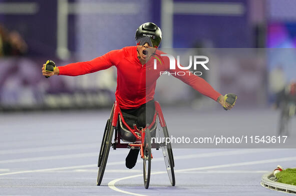 Hua Jin of People's Republic of China celebrates winning gold in Men's 1500m - T54 Final during the Paris 2024 Paralympic Games at Stade de...