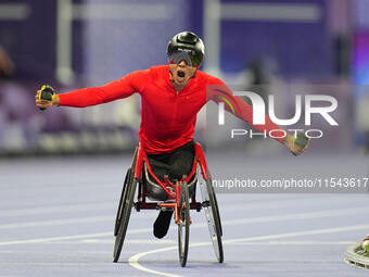 Hua Jin of People's Republic of China celebrates winning gold in Men's 1500m - T54 Final during the Paris 2024 Paralympic Games at Stade de...