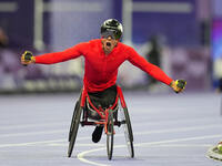 Hua Jin of People's Republic of China celebrates winning gold in Men's 1500m - T54 Final during the Paris 2024 Paralympic Games at Stade de...