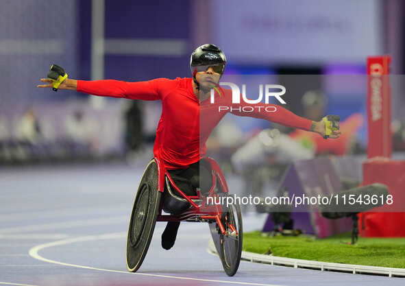 Hua Jin of People's Republic of China celebrates winning gold in Men's 1500m - T54 Final during the Paris 2024 Paralympic Games at Stade de...