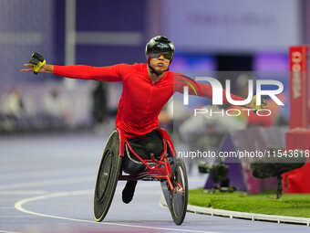 Hua Jin of People's Republic of China celebrates winning gold in Men's 1500m - T54 Final during the Paris 2024 Paralympic Games at Stade de...