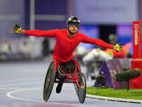 Hua Jin of People's Republic of China celebrates winning gold in Men's 1500m - T54 Final during the Paris 2024 Paralympic Games at Stade de...