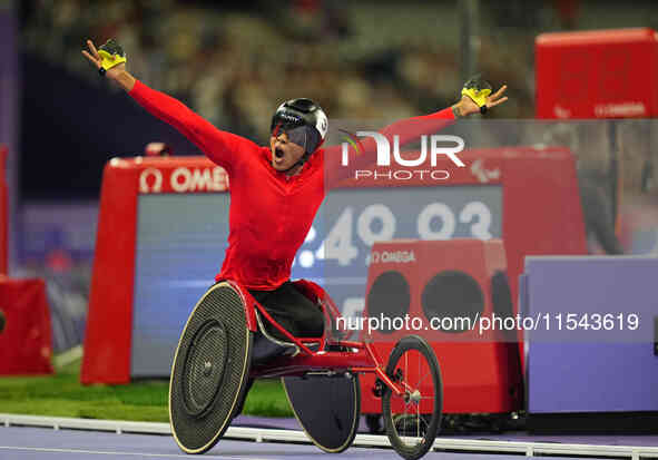 Hua Jin of People's Republic of China celebrates winning gold in Men's 1500m - T54 Final during the Paris 2024 Paralympic Games at Stade de...