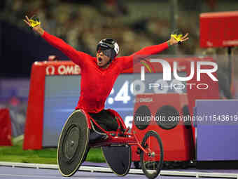 Hua Jin of People's Republic of China celebrates winning gold in Men's 1500m - T54 Final during the Paris 2024 Paralympic Games at Stade de...