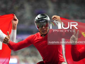 Hua Jin of People's Republic of China celebrates winning gold in Men's 1500m - T54 Final during the Paris 2024 Paralympic Games at Stade de...