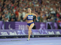 Nataliia Kobzar of Ukraine celebrates winning gold in Women's 400m - T37 Final during the Paris 2024 Paralympic Games at Stade de France on...