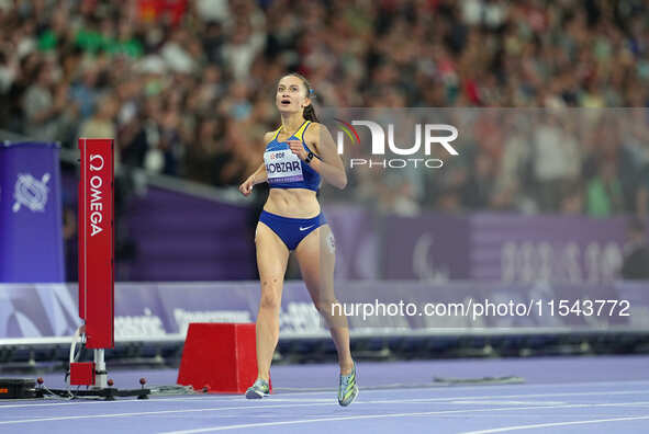 Nataliia Kobzar of Ukraine celebrates winning gold in Women's 400m - T37 Final during the Paris 2024 Paralympic Games at Stade de France on...