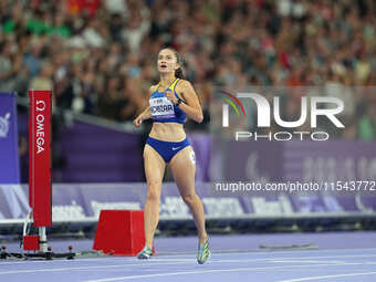 Nataliia Kobzar of Ukraine celebrates winning gold in Women's 400m - T37 Final during the Paris 2024 Paralympic Games at Stade de France on...