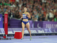 Nataliia Kobzar of Ukraine celebrates winning gold in Women's 400m - T37 Final during the Paris 2024 Paralympic Games at Stade de France on...