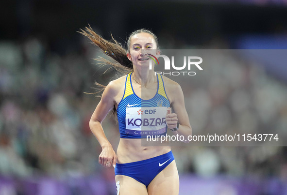 Nataliia Kobzar of Ukraine celebrates winning gold in Women's 400m - T37 Final during the Paris 2024 Paralympic Games at Stade de France on...