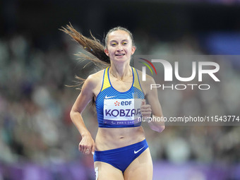 Nataliia Kobzar of Ukraine celebrates winning gold in Women's 400m - T37 Final during the Paris 2024 Paralympic Games at Stade de France on...