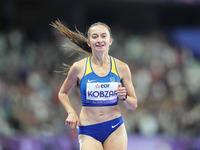 Nataliia Kobzar of Ukraine celebrates winning gold in Women's 400m - T37 Final during the Paris 2024 Paralympic Games at Stade de France on...