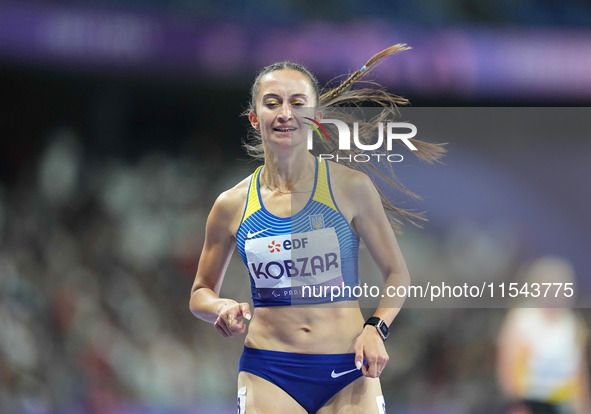 Nataliia Kobzar of Ukraine celebrates winning gold in Women's 400m - T37 Final during the Paris 2024 Paralympic Games at Stade de France on...