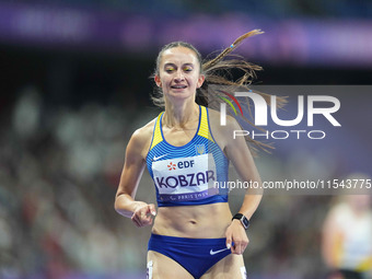 Nataliia Kobzar of Ukraine celebrates winning gold in Women's 400m - T37 Final during the Paris 2024 Paralympic Games at Stade de France on...