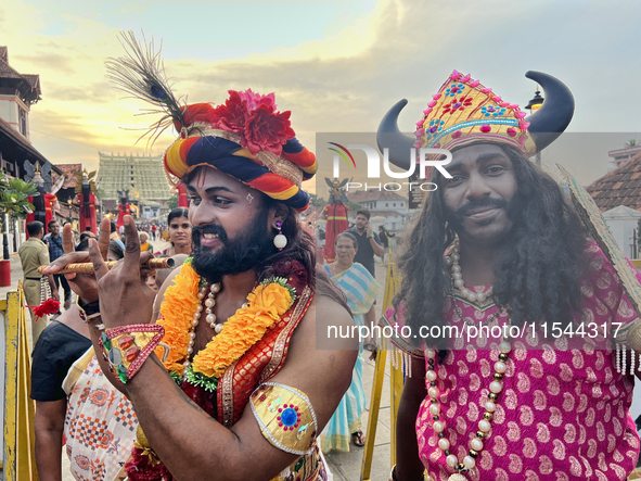 Hindu devotees dress in colorful costumes at the historic Sree Padmanabhaswamy Temple during the Panguni Utsavam (Painkuni Utsavam) festival...