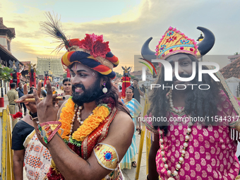 Hindu devotees dress in colorful costumes at the historic Sree Padmanabhaswamy Temple during the Panguni Utsavam (Painkuni Utsavam) festival...