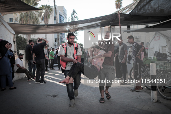 A number of martyrs and wounded, most of them children, arrive at the Arab High Hospital from different areas of Gaza City on September 3, 2...