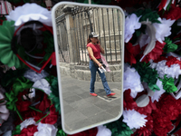 A woman reflects in a mirror in the Zocalo of Mexico City, Mexico, on September 3, 2024, on the eve of the Grito de Independencia of Mexico...