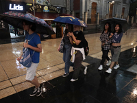 Passersby walk in the rain on Madero Avenue in Mexico City, Mexico, on September 3, 2024, on the eve of Mexican Independence Day on Septembe...