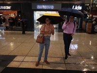 Passersby walk in the rain on Madero Avenue in Mexico City, Mexico, on September 3, 2024, on the eve of Mexican Independence Day on Septembe...