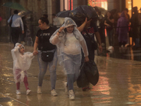 Passersby walk in the rain on Madero Avenue in Mexico City, Mexico, on September 3, 2024, on the eve of Mexican Independence Day on Septembe...