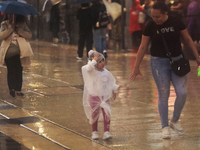 Passersby walk in the rain on Madero Avenue in Mexico City, Mexico, on September 3, 2024, on the eve of Mexican Independence Day on Septembe...