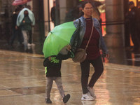 Passersby walk in the rain on Madero Avenue in Mexico City, Mexico, on September 3, 2024, on the eve of Mexican Independence Day on Septembe...