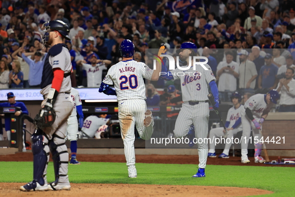 Pete Alonso #20 of the New York Mets celebrates with teammate Jesse Winker after homering during the eighth inning of the baseball game agai...