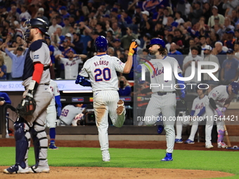 Pete Alonso #20 of the New York Mets celebrates with teammate Jesse Winker after homering during the eighth inning of the baseball game agai...