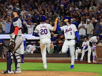 Pete Alonso #20 of the New York Mets celebrates with teammate Jesse Winker after homering during the eighth inning of the baseball game agai...