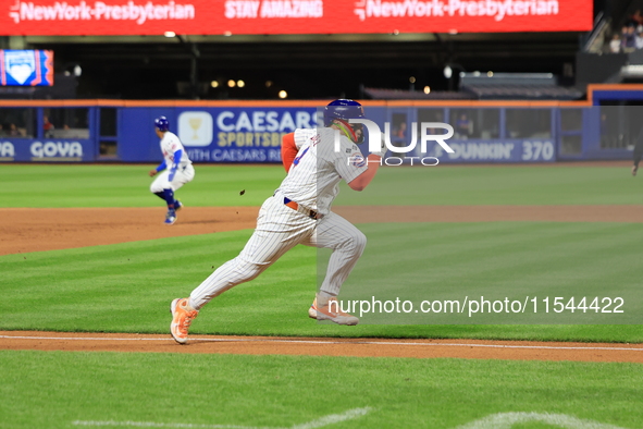 New York Mets Francisco Alvarez #4 scores on a sacrifice fly during the eighth inning of the baseball game against the Boston Red Sox at Cit...