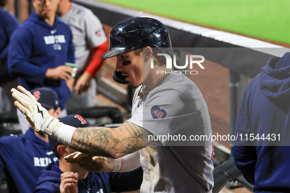 Boston Red Sox Jarren Duran #16 is congratulated after scoring on a sacrifice fly during the sixth inning of the baseball game against the N...