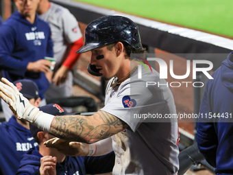 Boston Red Sox Jarren Duran #16 is congratulated after scoring on a sacrifice fly during the sixth inning of the baseball game against the N...