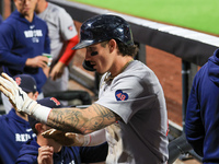 Boston Red Sox Jarren Duran #16 is congratulated after scoring on a sacrifice fly during the sixth inning of the baseball game against the N...