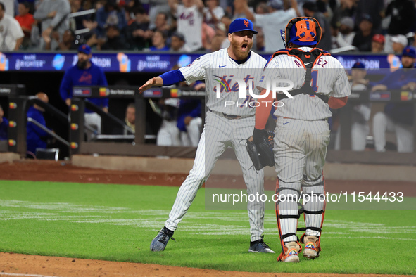 New York Mets relief pitcher Reed Garrett #75 celebrates an inning-ending double play with catcher Francisco Alvarez #4 during the eighth in...