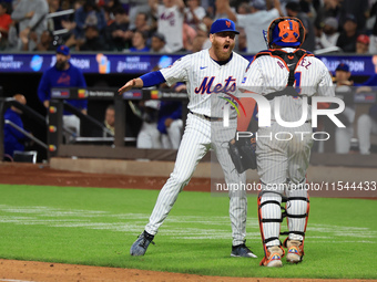 New York Mets relief pitcher Reed Garrett #75 celebrates an inning-ending double play with catcher Francisco Alvarez #4 during the eighth in...