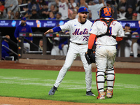 New York Mets relief pitcher Reed Garrett #75 celebrates an inning-ending double play with catcher Francisco Alvarez #4 during the eighth in...