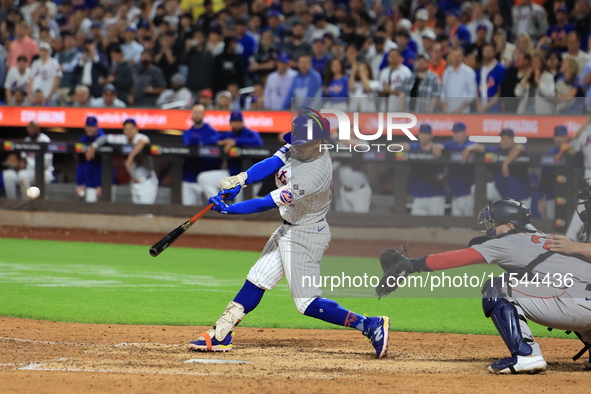 Francisco Lindor #12 of the New York Mets doubles during the eighth inning of the baseball game against the Boston Red Sox at Citi Field in...