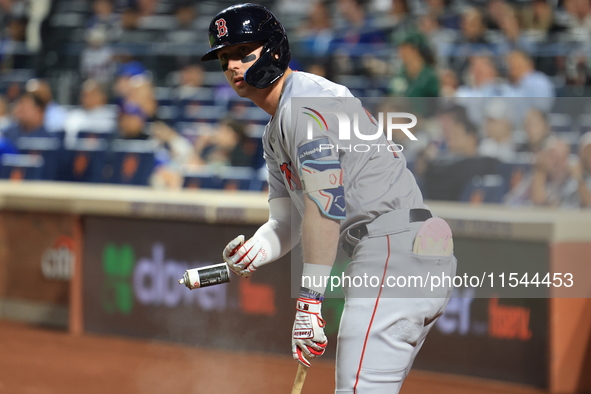 Nick Sogard #75 of the Boston Red Sox tosses a can containing a sticky substance during the third inning of the baseball game against the Ne...