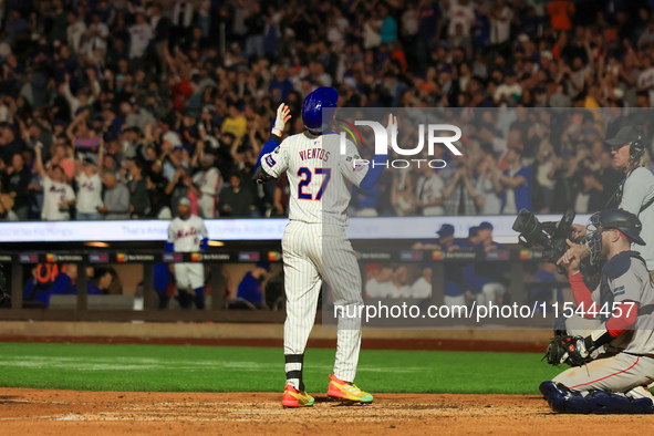 Mark Vientos #27 of the New York Mets touches home plate after homering during the seventh inning of the baseball game against the Boston Re...