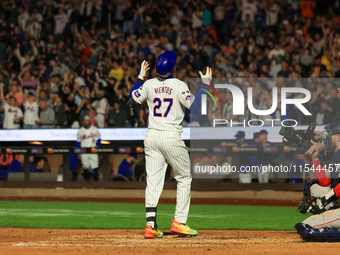 Mark Vientos #27 of the New York Mets touches home plate after homering during the seventh inning of the baseball game against the Boston Re...