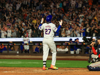 Mark Vientos #27 of the New York Mets touches home plate after homering during the seventh inning of the baseball game against the Boston Re...