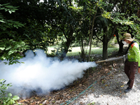 A health worker fumigates to prevent the spread of Dengue fever at a village in Nakhon Sawan province, north of Bangkok, on September 4, 202...