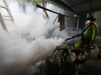 A health worker fumigates to prevent the spread of Dengue fever at a village in Nakhon Sawan province, north of Bangkok, on September 4, 202...