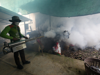 A health worker fumigates to prevent the spread of Dengue fever at a village in Nakhon Sawan province, north of Bangkok, on September 4, 202...