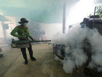 A health worker fumigates to prevent the spread of Dengue fever at a village in Nakhon Sawan province, north of Bangkok, on September 4, 202...