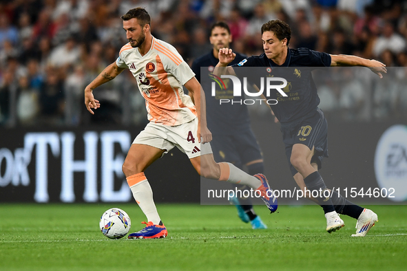 Bryan Cristante of AS Roma fights for the ball with Kenan Yildiz of Juventus during the Serie A match between Juventus FC and AS Roma at All...