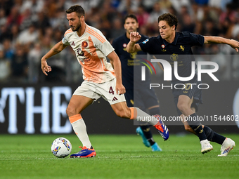 Bryan Cristante of AS Roma fights for the ball with Kenan Yildiz of Juventus during the Serie A match between Juventus FC and AS Roma at All...