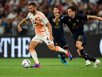 Bryan Cristante of AS Roma fights for the ball with Kenan Yildiz of Juventus during the Serie A match between Juventus FC and AS Roma at All...